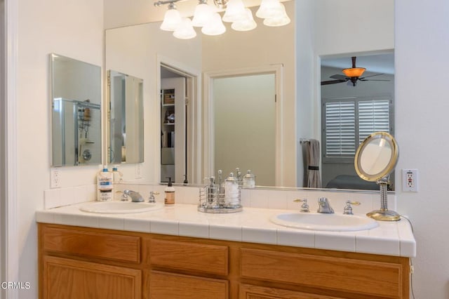 bathroom featuring vanity, a shower with door, and ceiling fan