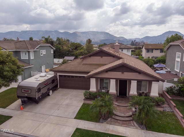 view of front of home featuring a mountain view and a garage