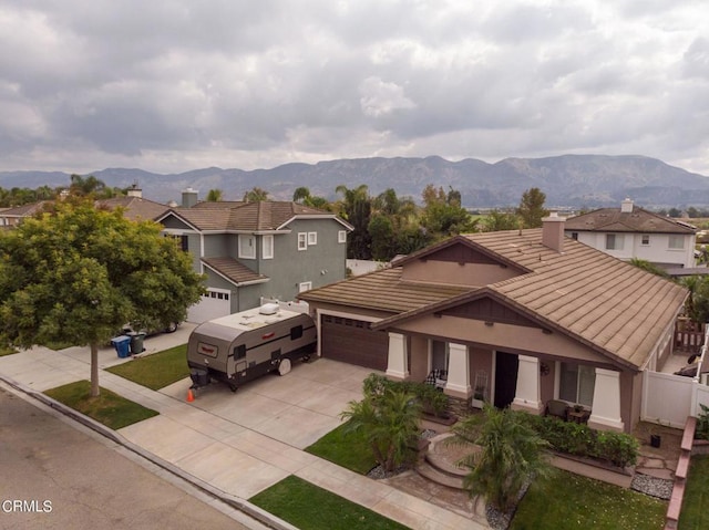 view of front of house featuring a garage and a mountain view