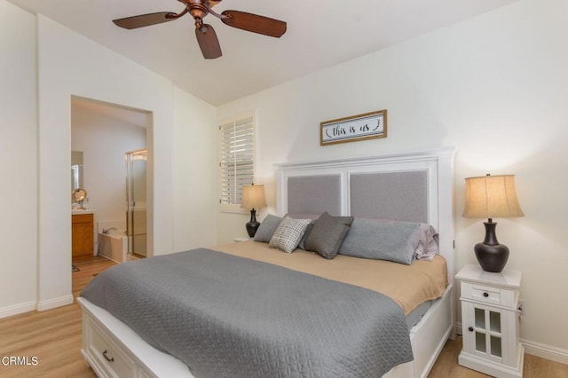 bedroom with vaulted ceiling, ensuite bathroom, ceiling fan, and light wood-type flooring