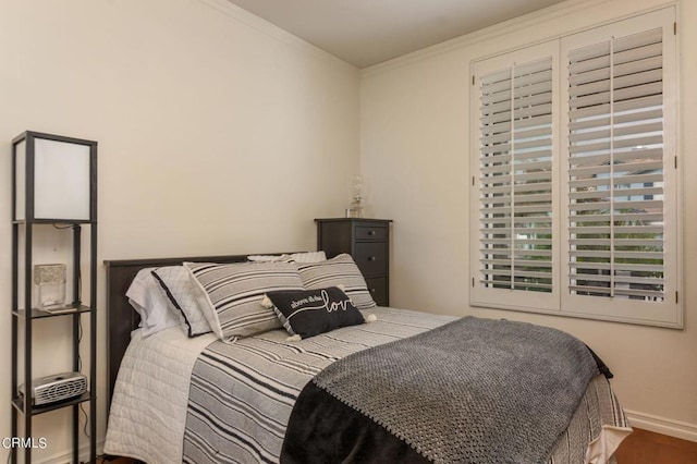 bedroom featuring hardwood / wood-style floors and ornamental molding