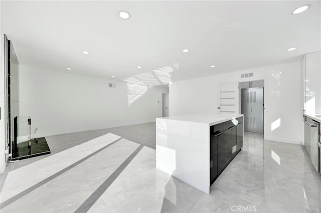 kitchen featuring a large island and white cabinets