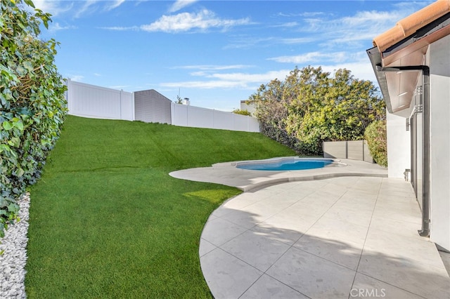 view of yard with a fenced in pool and a patio