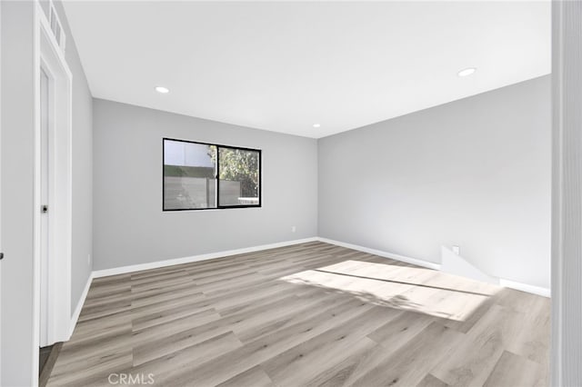 spare room featuring light hardwood / wood-style floors