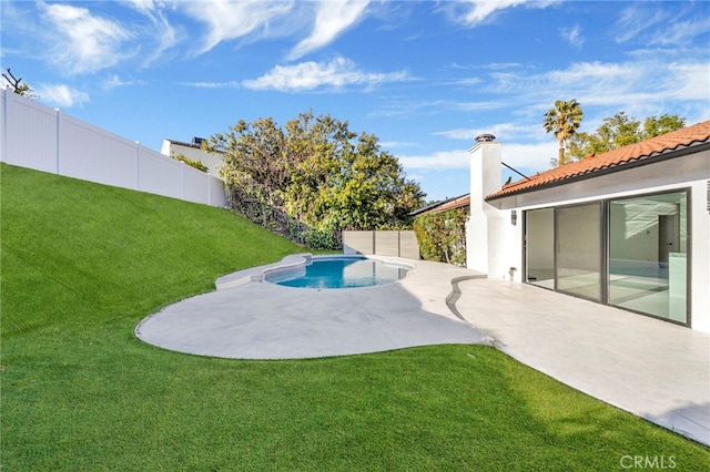 view of pool with a lawn and a patio