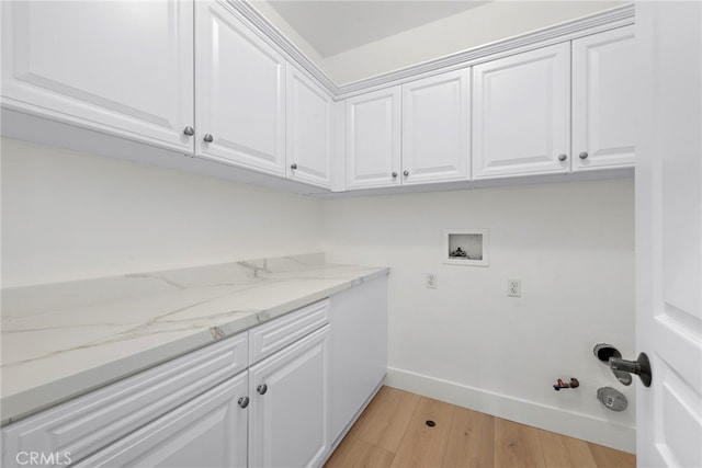 washroom featuring cabinets, hookup for a gas dryer, washer hookup, and light hardwood / wood-style flooring