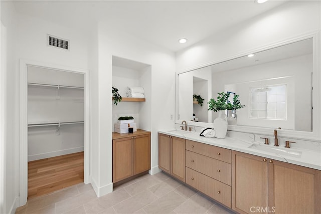 bathroom with tile patterned flooring and vanity