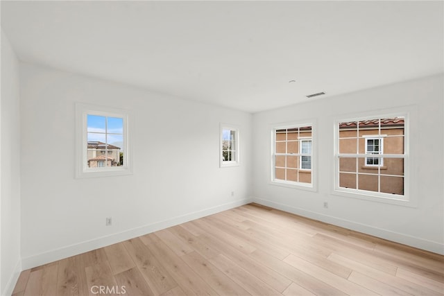 spare room featuring light wood-type flooring