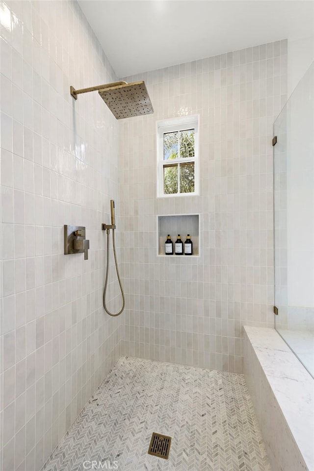 bathroom with a tile shower