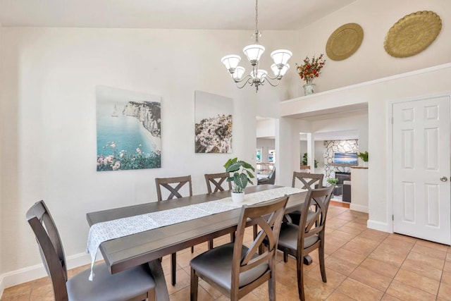 tiled dining area featuring an inviting chandelier and a towering ceiling