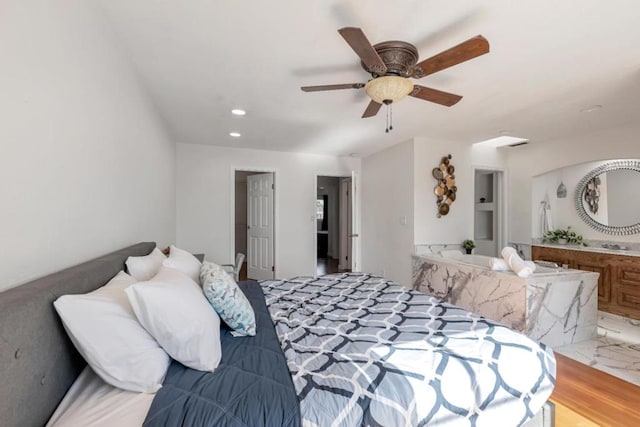 bedroom featuring ceiling fan and ensuite bath