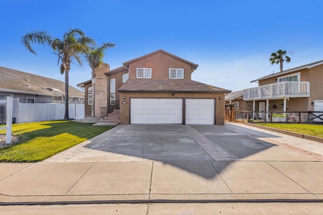 view of front of home featuring a garage and a front lawn