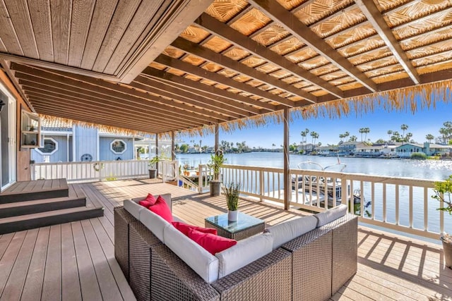 wooden deck with outdoor lounge area and a water view