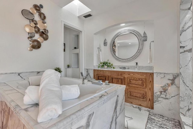 bathroom with vanity and a skylight