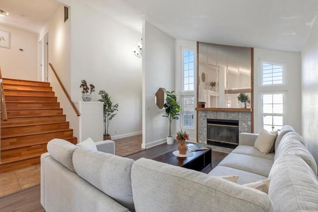 living room featuring dark hardwood / wood-style flooring, high vaulted ceiling, and a fireplace