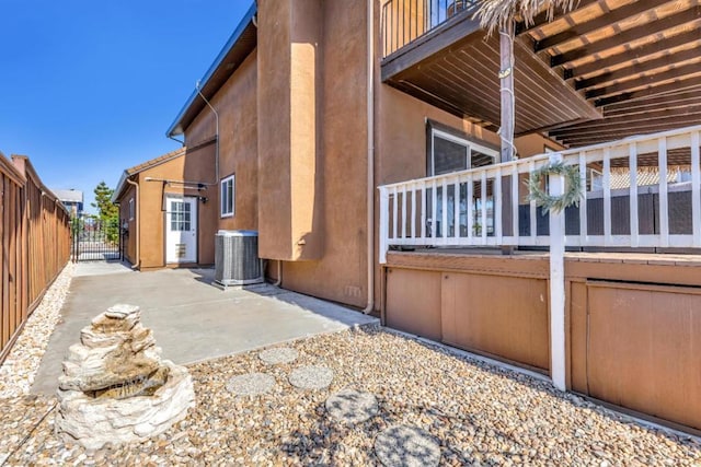 view of side of home with central AC and a patio area