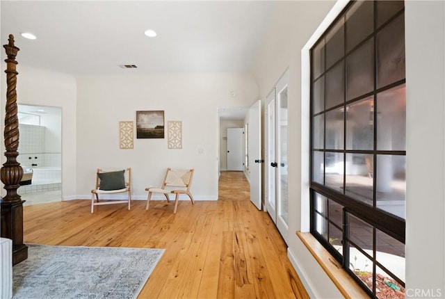 hallway with hardwood / wood-style floors