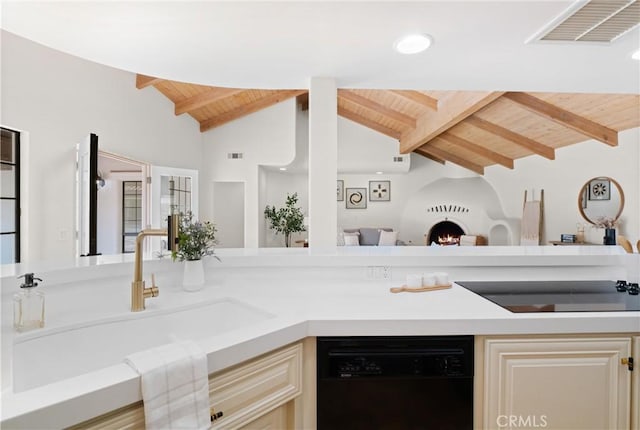 kitchen with lofted ceiling with beams, dishwasher, sink, wooden ceiling, and cream cabinetry