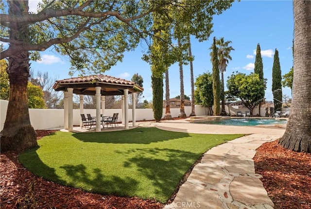 view of yard featuring a gazebo, a fenced in pool, and a patio area