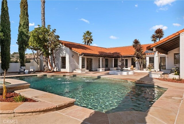 view of swimming pool with a patio and pool water feature