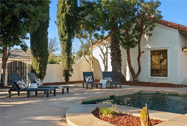 view of property's community featuring a pool and a patio