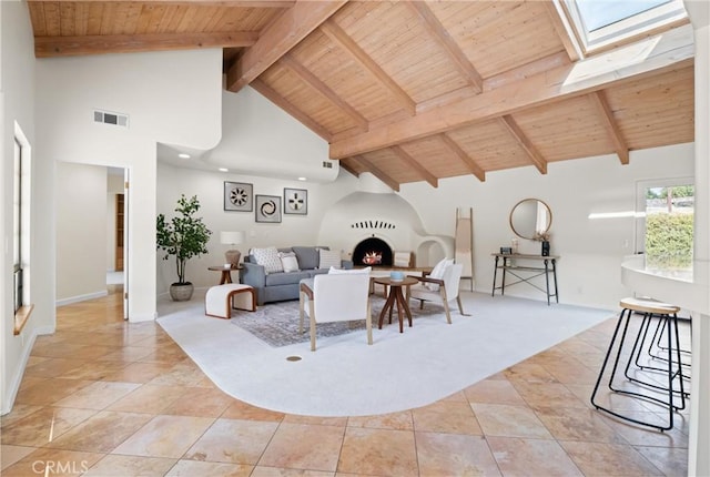 living room with a skylight, high vaulted ceiling, light tile patterned floors, wooden ceiling, and beamed ceiling