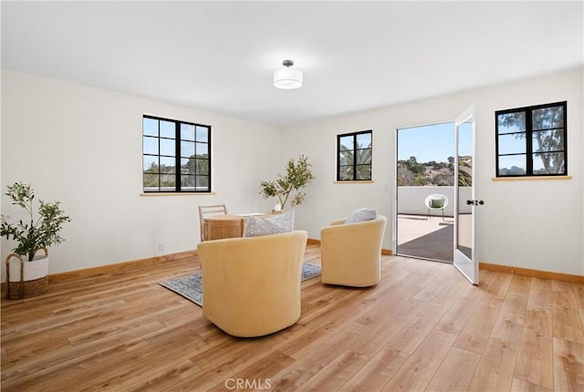 living area with plenty of natural light and light wood-type flooring