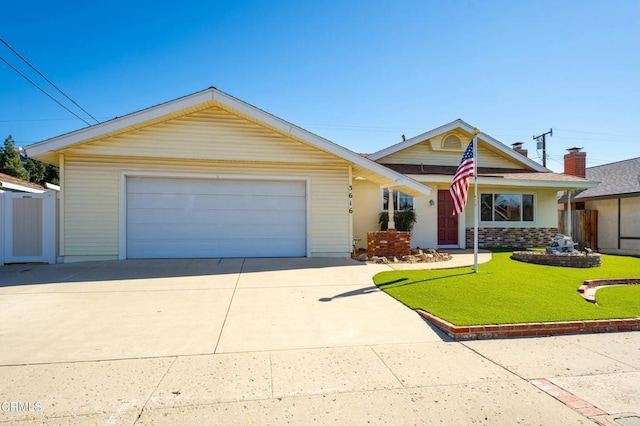 view of front of house with driveway, a front lawn, and an attached garage