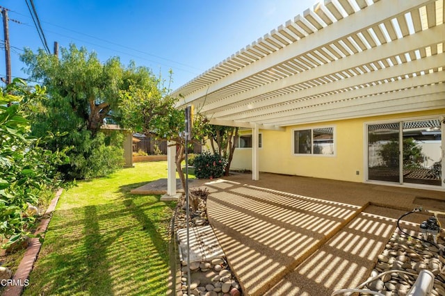 view of yard featuring a patio, fence, and a pergola