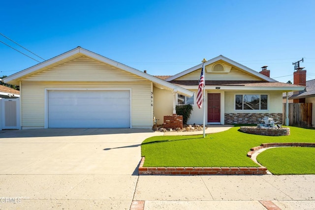 view of front of house featuring a garage, driveway, a front yard, and fence