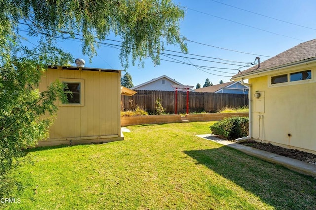 view of yard with an outbuilding and fence