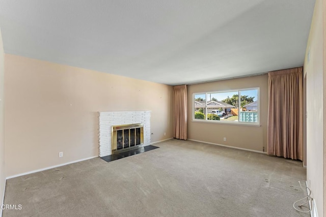 unfurnished living room featuring light carpet, a fireplace, and baseboards