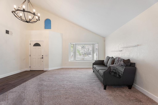 sitting room featuring carpet flooring, a notable chandelier, and high vaulted ceiling