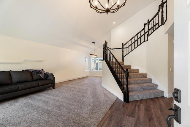 stairway featuring a notable chandelier, hardwood / wood-style flooring, and high vaulted ceiling