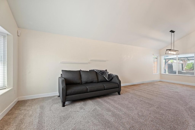 living area with light colored carpet, vaulted ceiling, and a notable chandelier