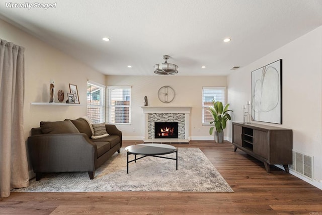 living room with hardwood / wood-style floors and a tile fireplace