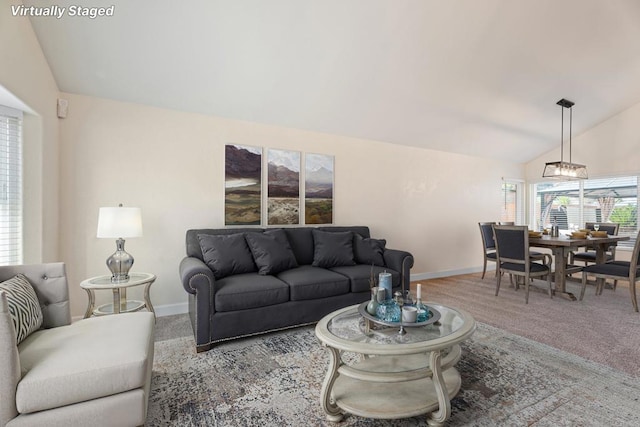 carpeted living room with vaulted ceiling