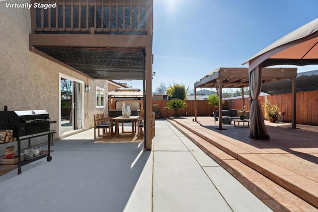 view of patio / terrace featuring an outdoor living space, a gazebo, and grilling area