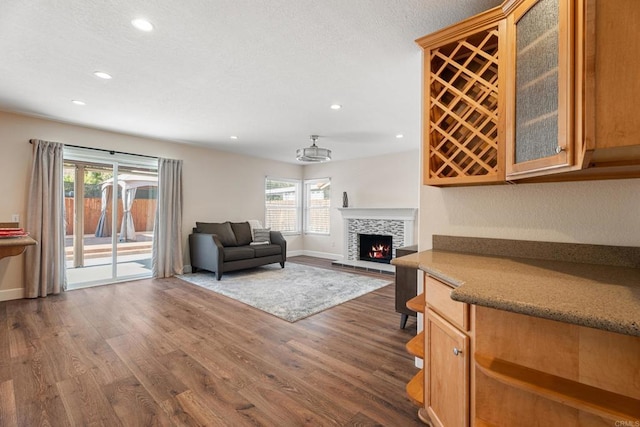 unfurnished living room with a fireplace and dark hardwood / wood-style floors