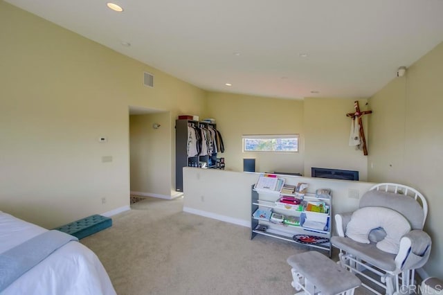 bedroom with vaulted ceiling and light colored carpet