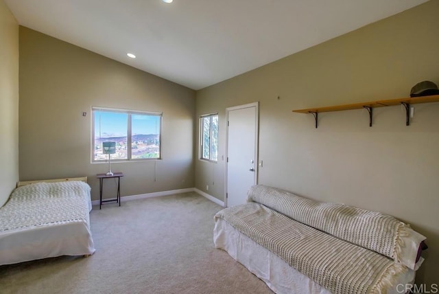 bedroom featuring vaulted ceiling and light carpet