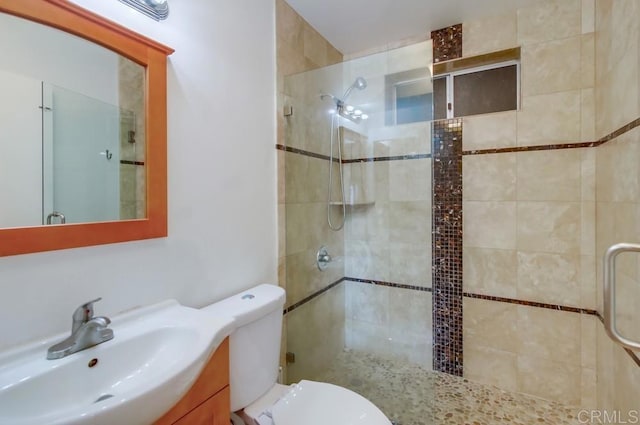 bathroom with toilet, vanity, and walk in shower