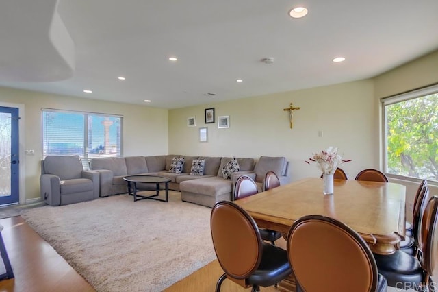 living area with recessed lighting, plenty of natural light, and wood finished floors