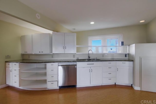 kitchen with a sink, white cabinets, stainless steel dishwasher, open shelves, and dark countertops