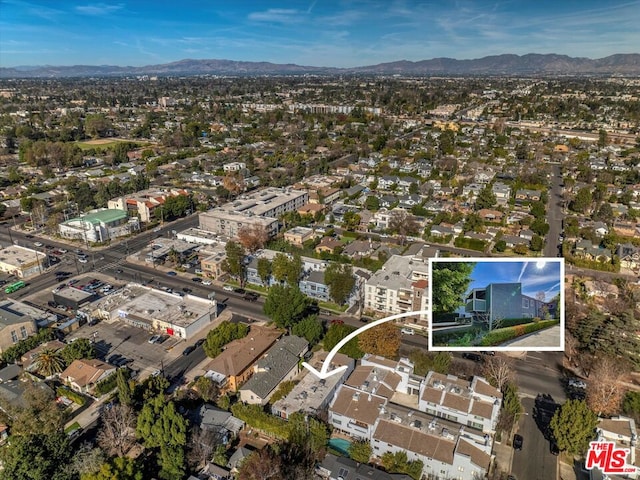 birds eye view of property with a mountain view