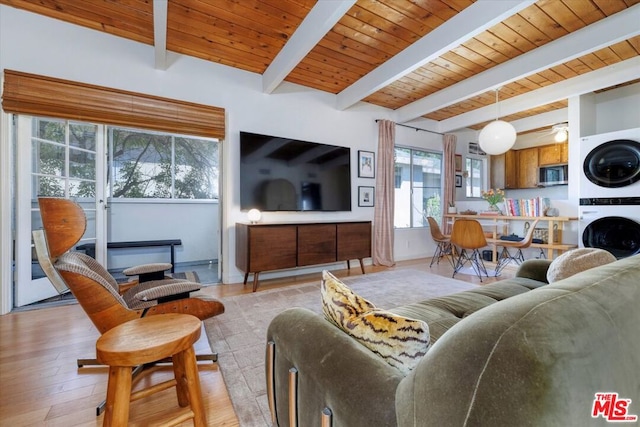 living room with wood ceiling, light hardwood / wood-style flooring, lofted ceiling with beams, and stacked washing maching and dryer