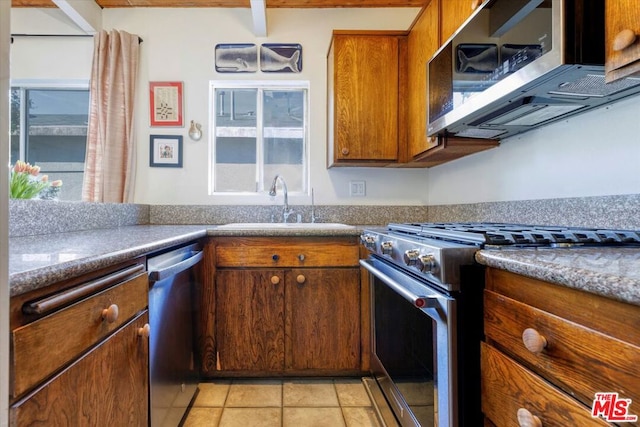 kitchen featuring light tile patterned flooring, stainless steel appliances, and sink