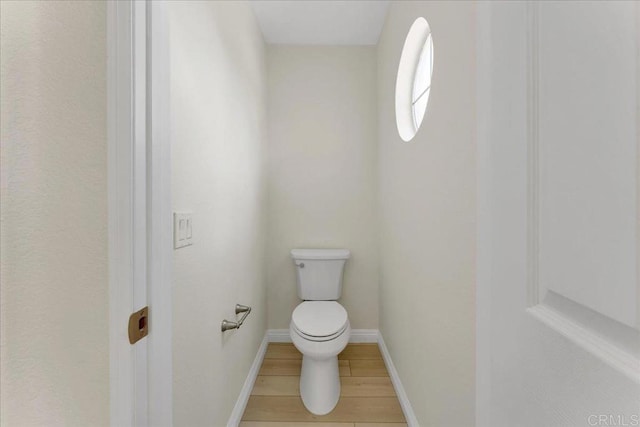 bathroom featuring hardwood / wood-style floors and toilet