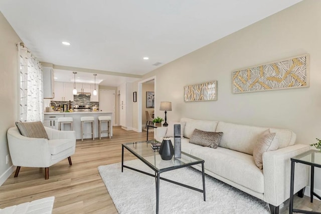 living room with light hardwood / wood-style flooring