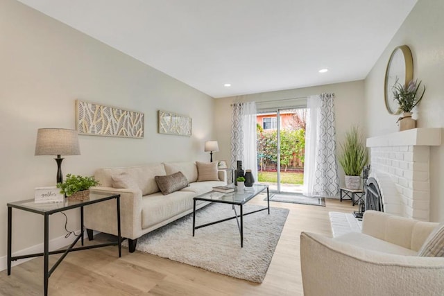 living room featuring a fireplace and light hardwood / wood-style flooring